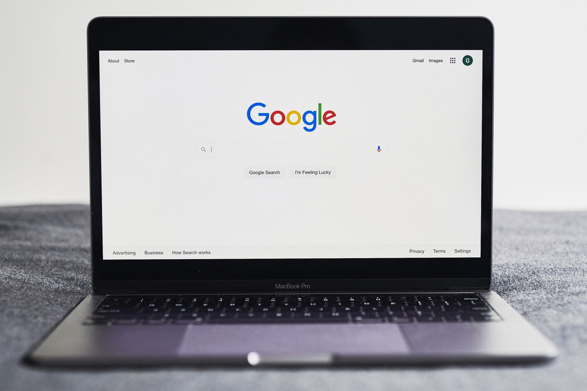 an open laptop to Google's home page search