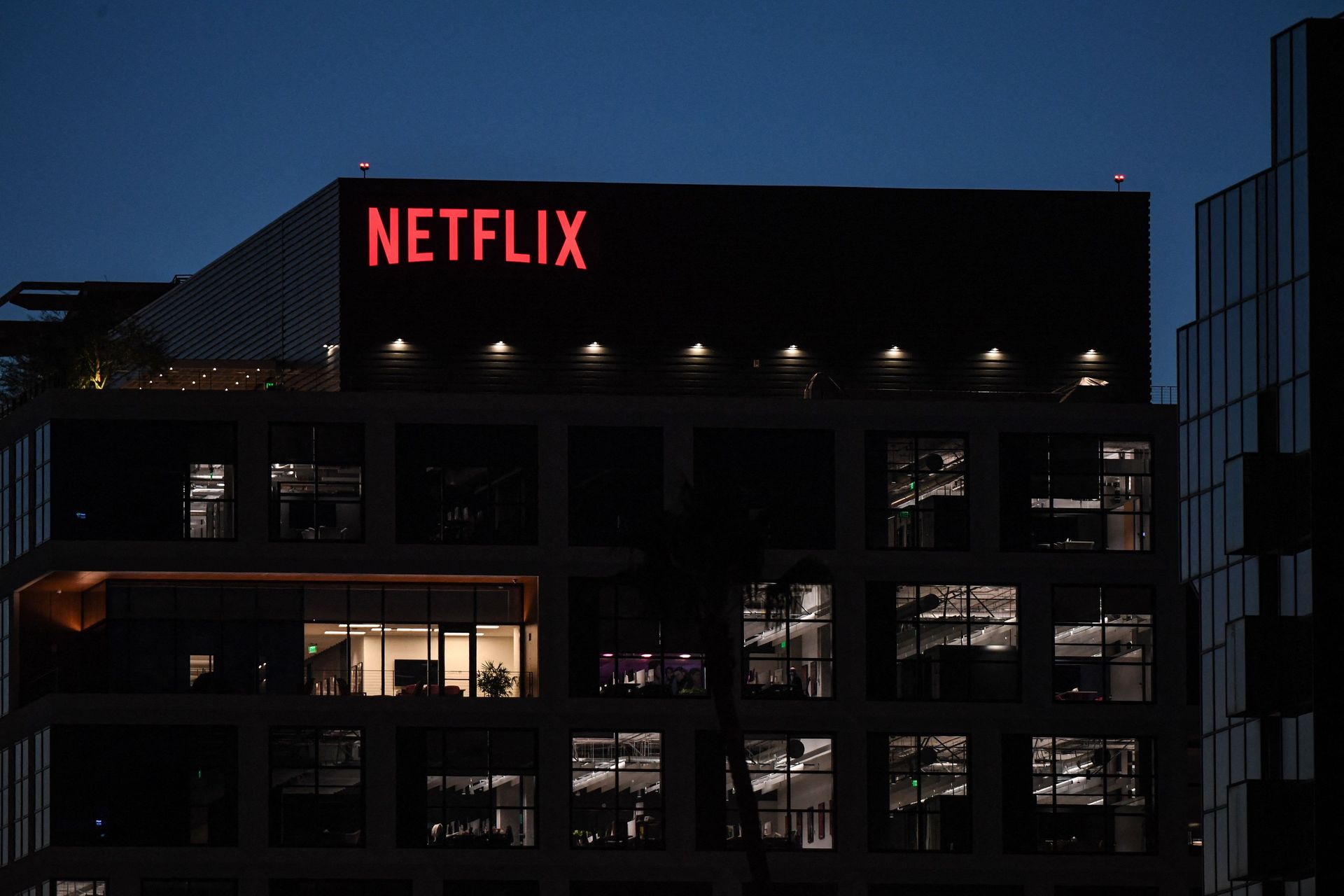 Netflix logo stands out on a building at night