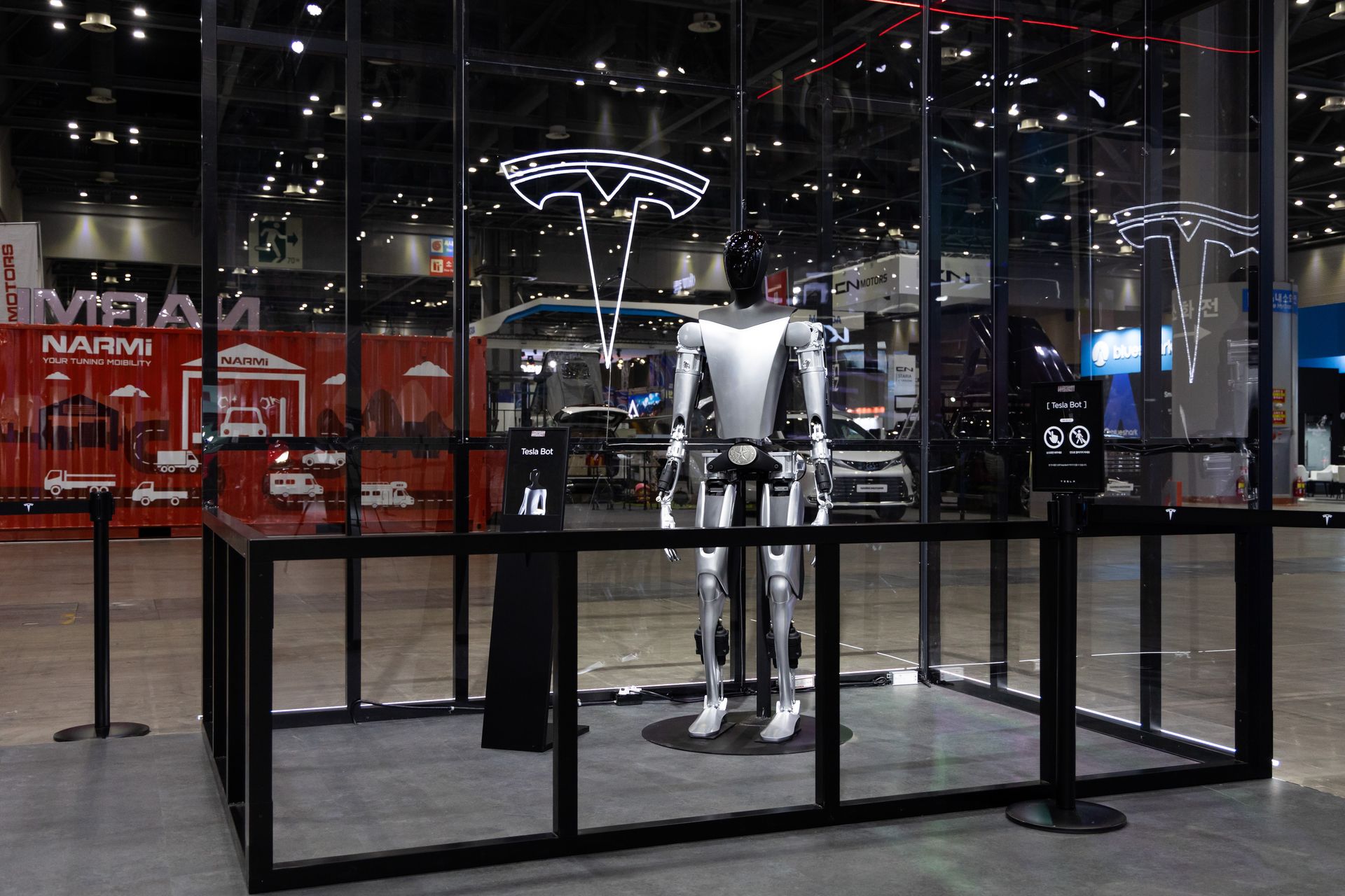 a Tesla humaoid robot stands in a display case