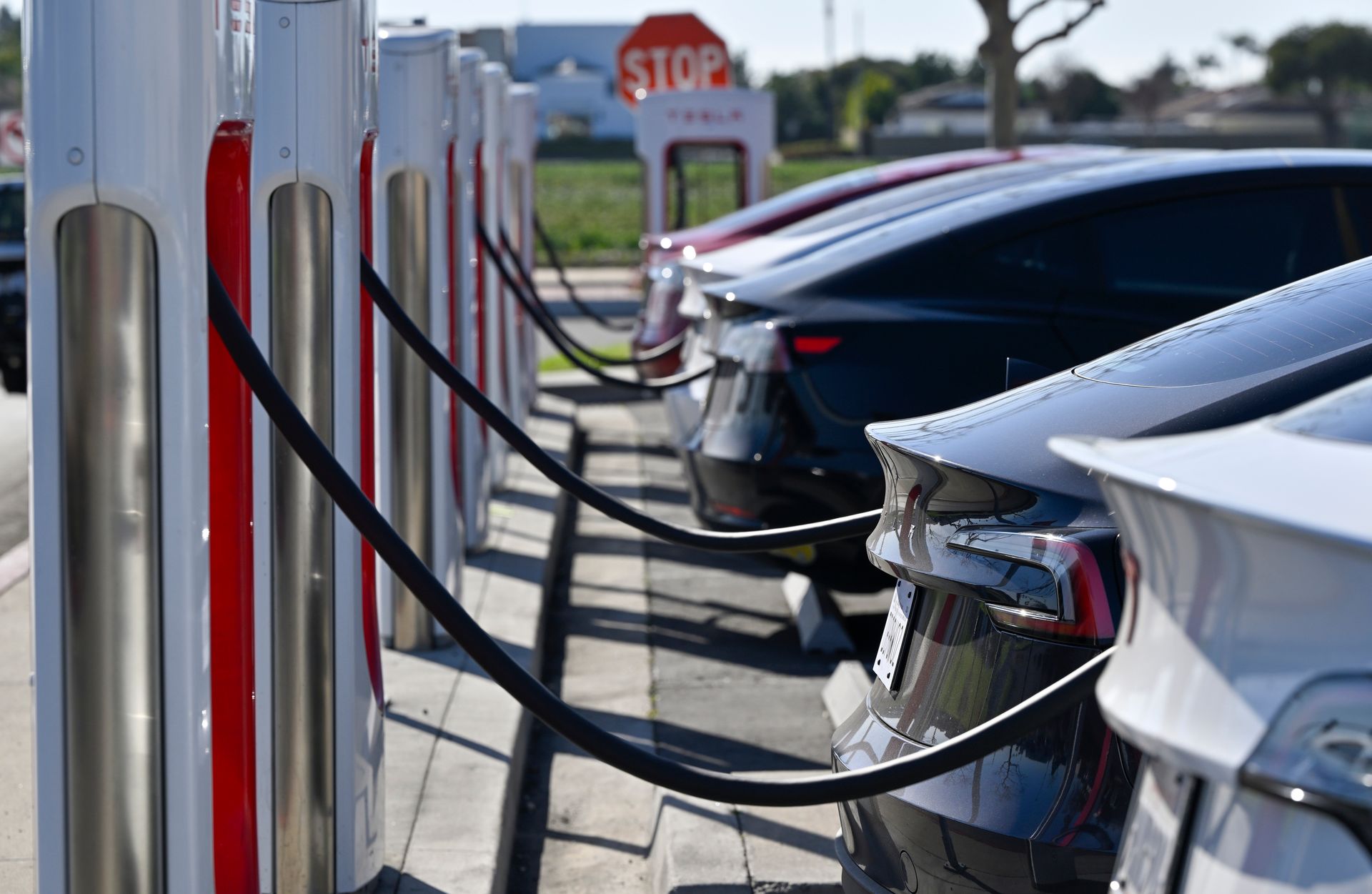 tesla vehicles plugged into superchargers