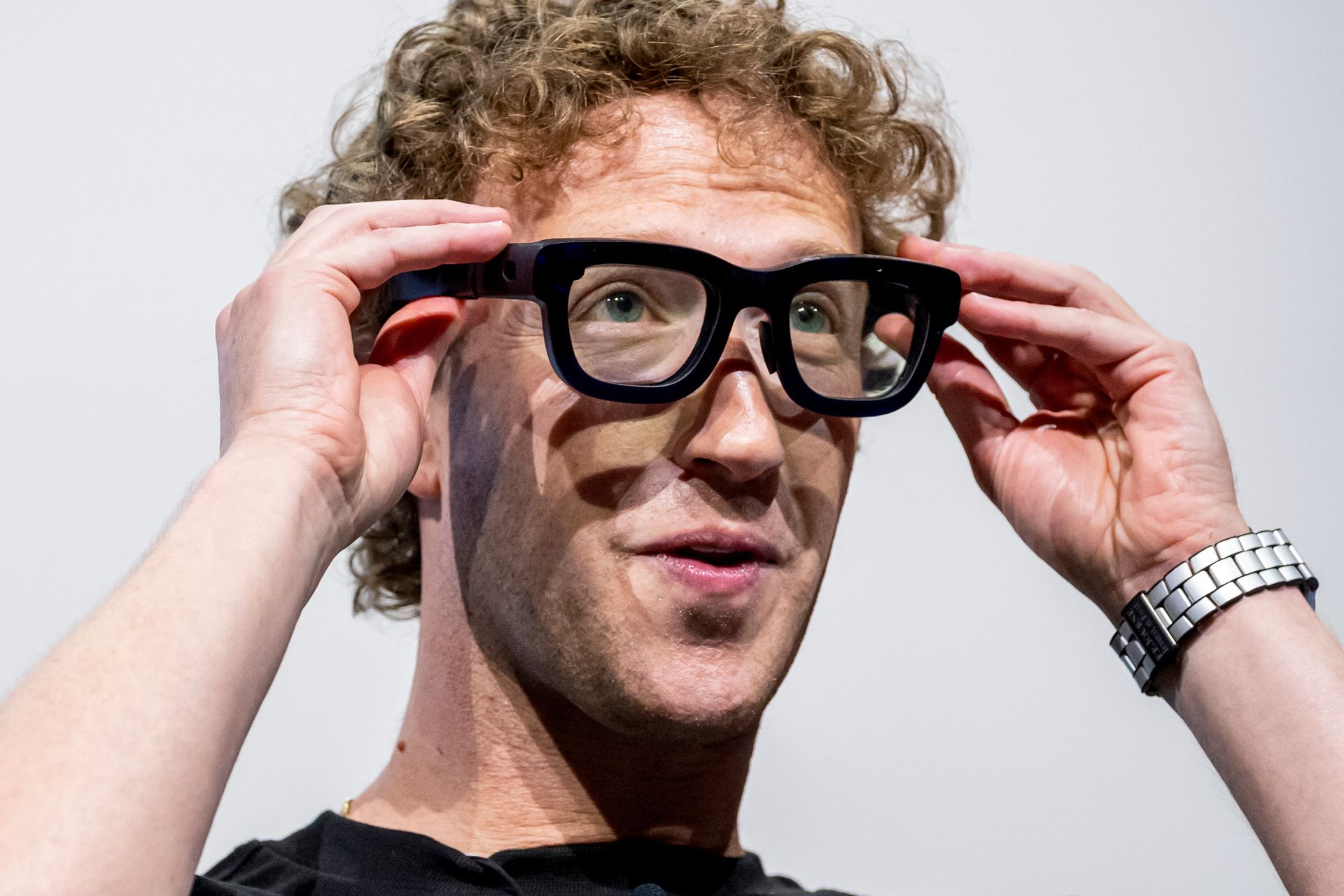 close-up of Mark Zuckerberg wearing thick-framed, black augmented reality glasses