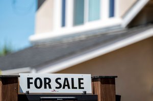 For Sale sign with reduced price