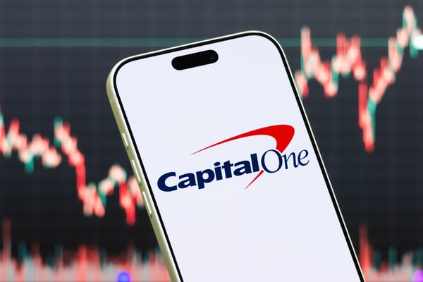 Capital One topped earnings estimates as credit losses fell and Discover integration progressed